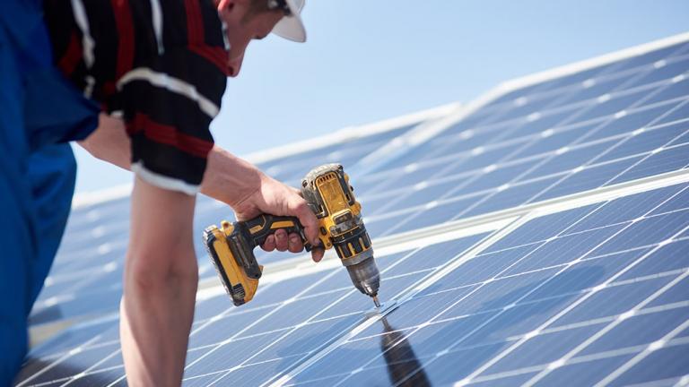 Man installing solar panels