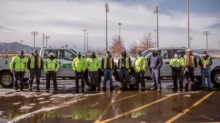 utility technicians standing in a parking lot