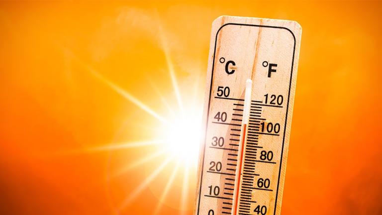 Thermostat over 100 degrees with the sun in the background