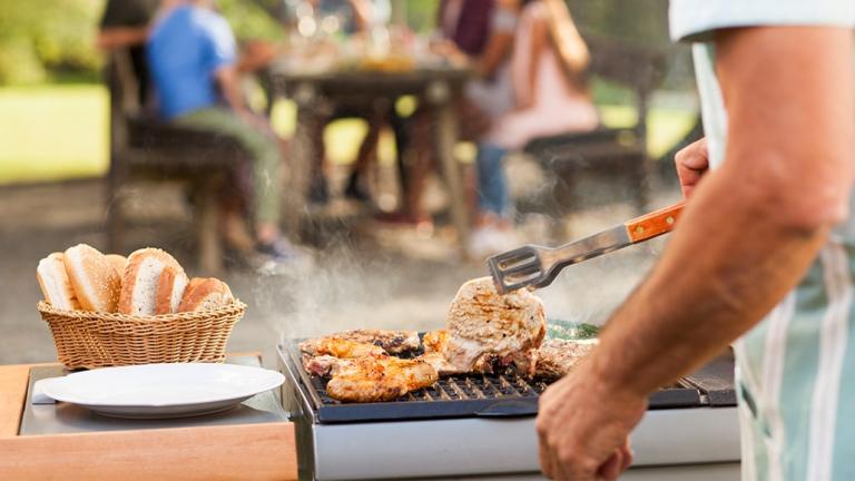 Man cooking on a bar-b-q.