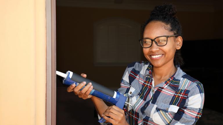 person with caulking gun