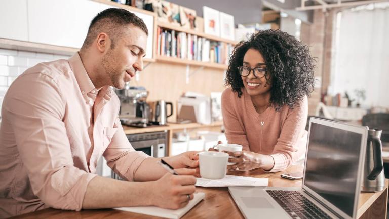 couple in a kitchen with laptop