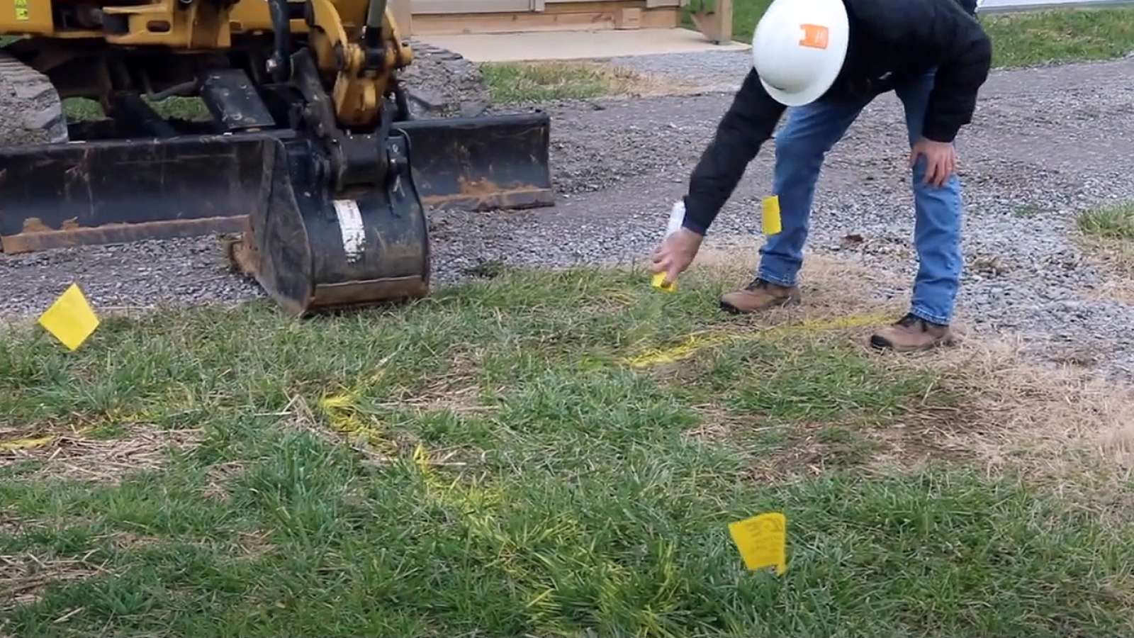 employee marking ground with spray paint