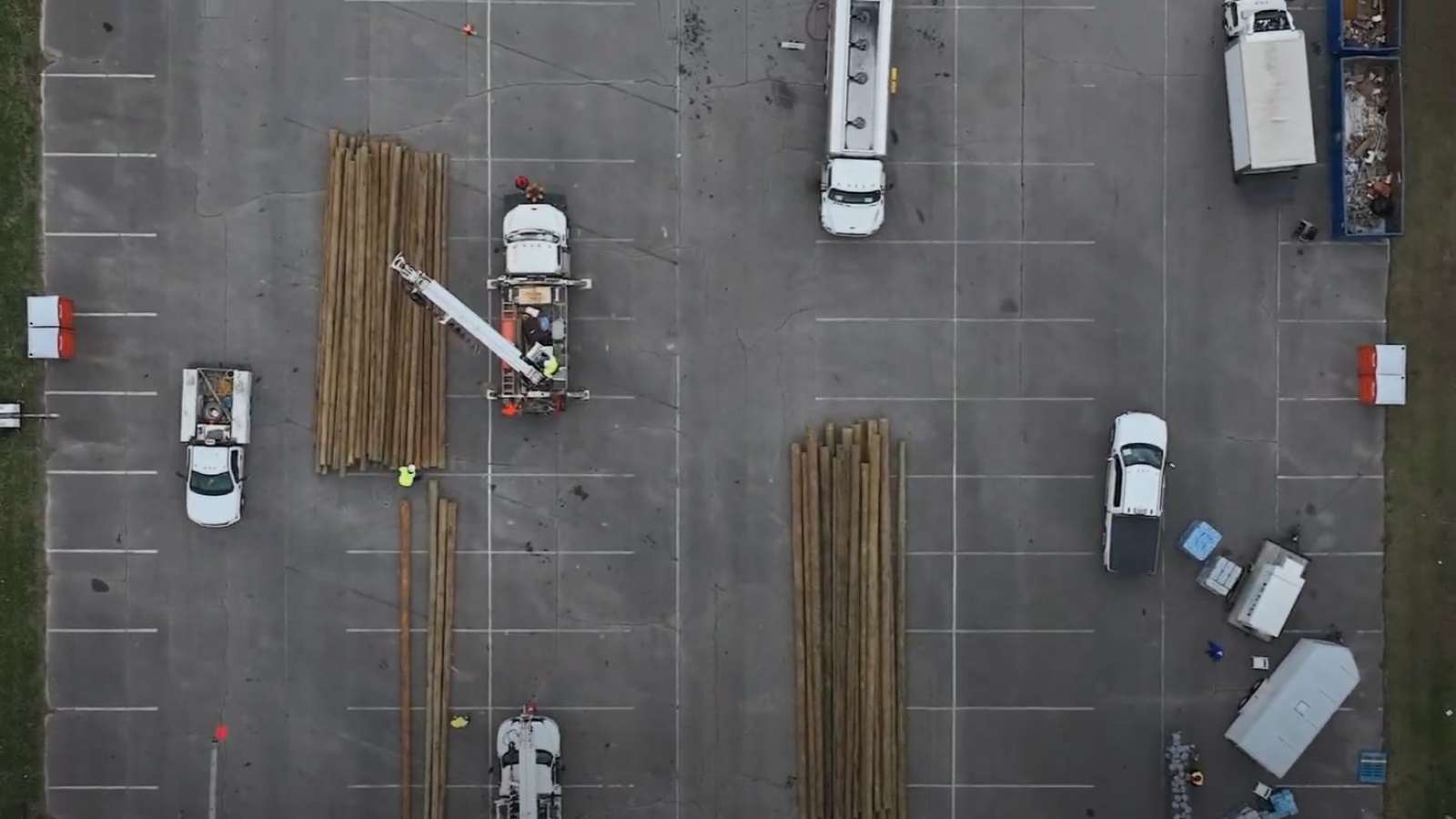 aerial view of parking lot with trucks and power poles