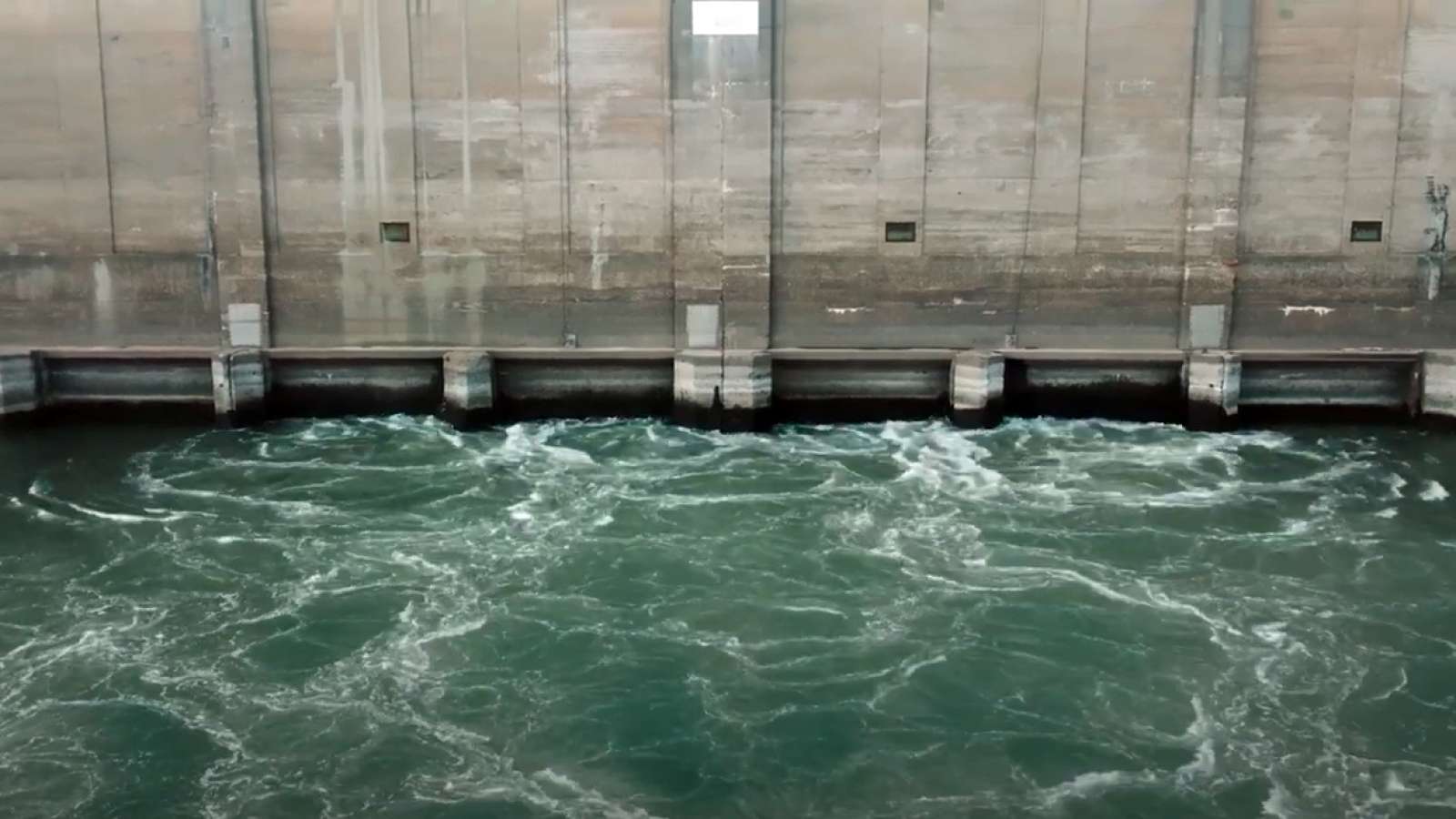 a hydroelectric dam with water rushing into it