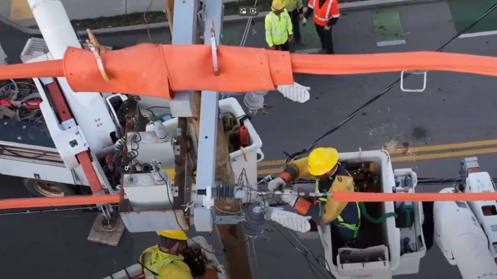 employees in bucket trucks safely restore power