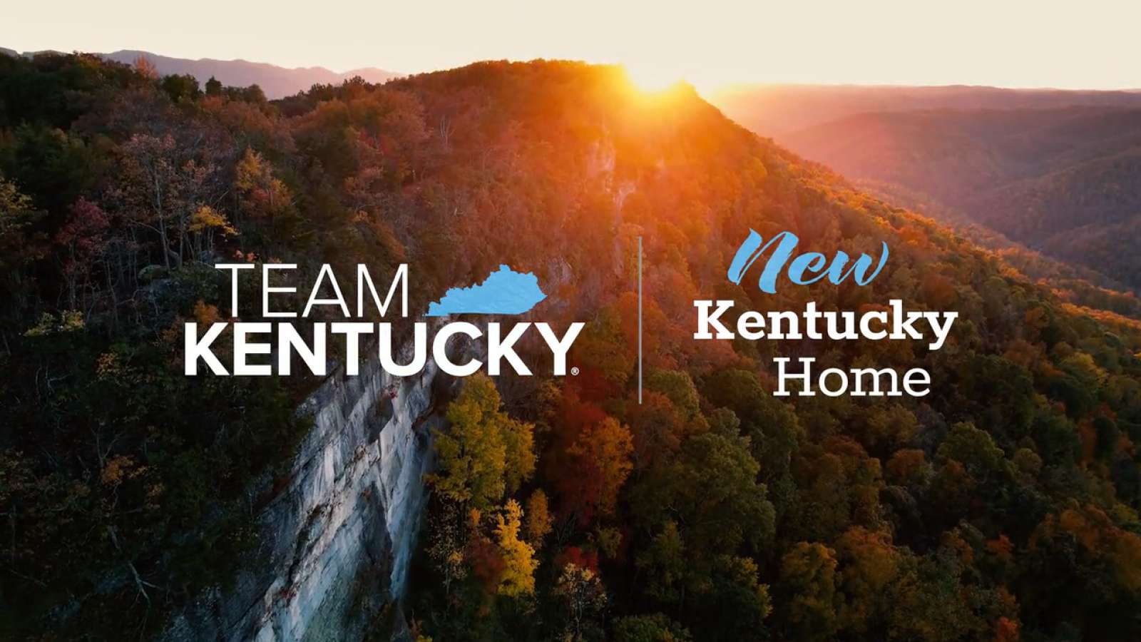 Team Kentucky and New Kentucky Home graphics over a wooded mountain