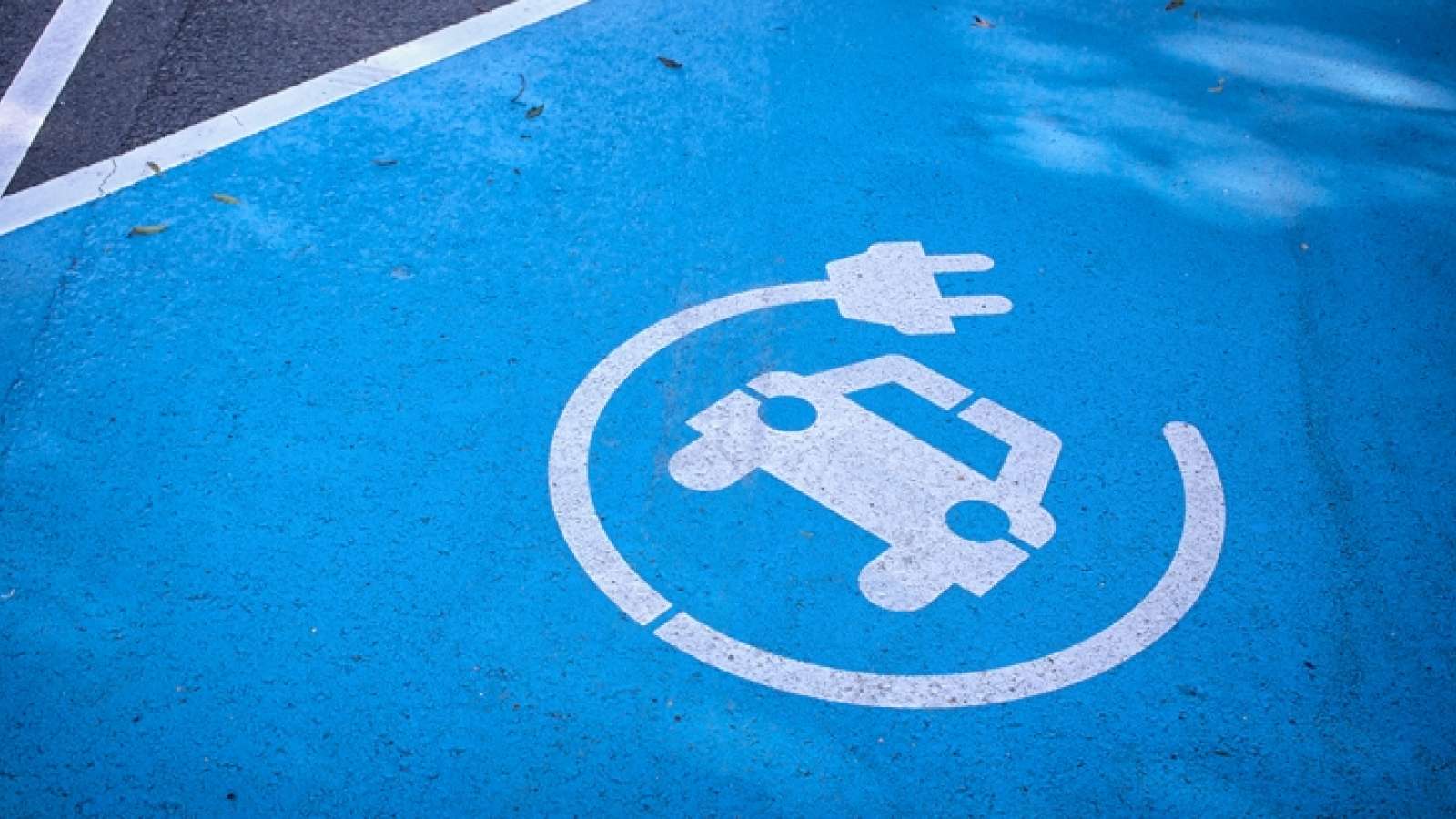 a blue painted parking spot designated as a charging station