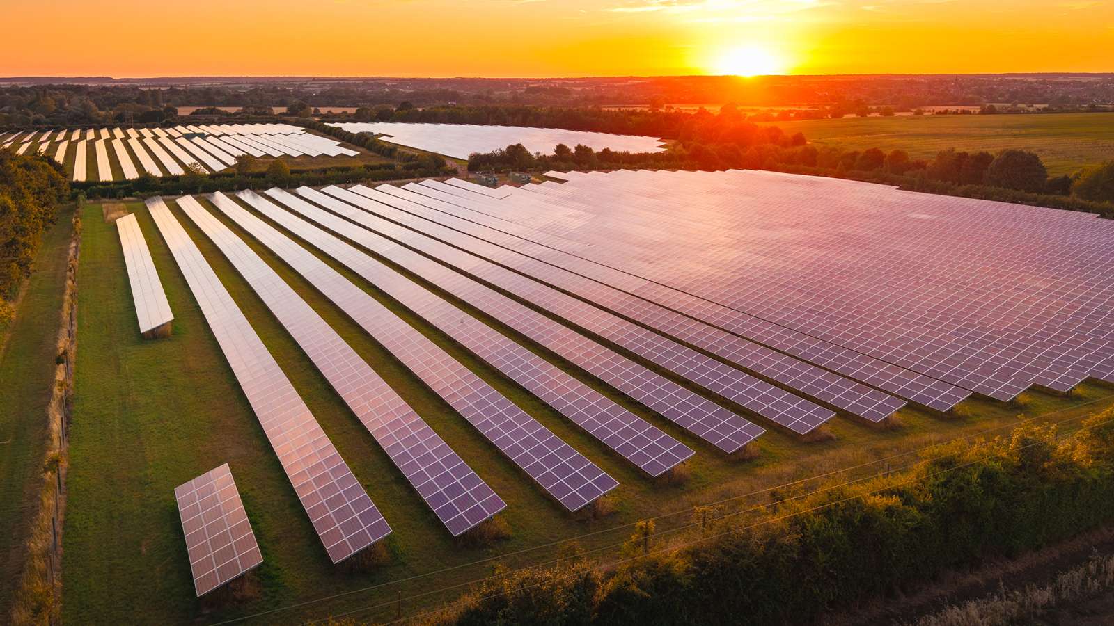 aerial view of a large solar farm at sunset
