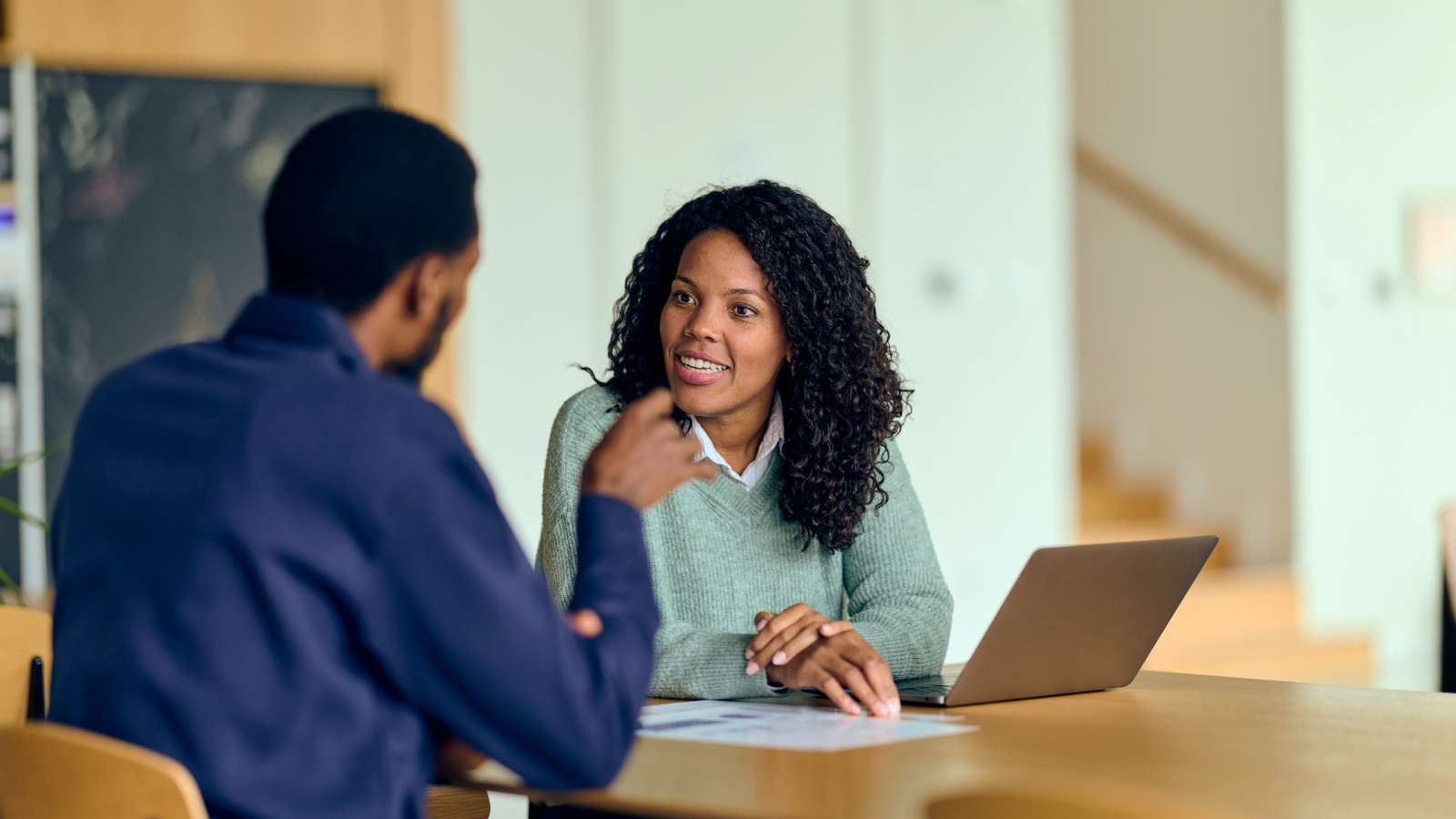 two people in a conference room having a discussion