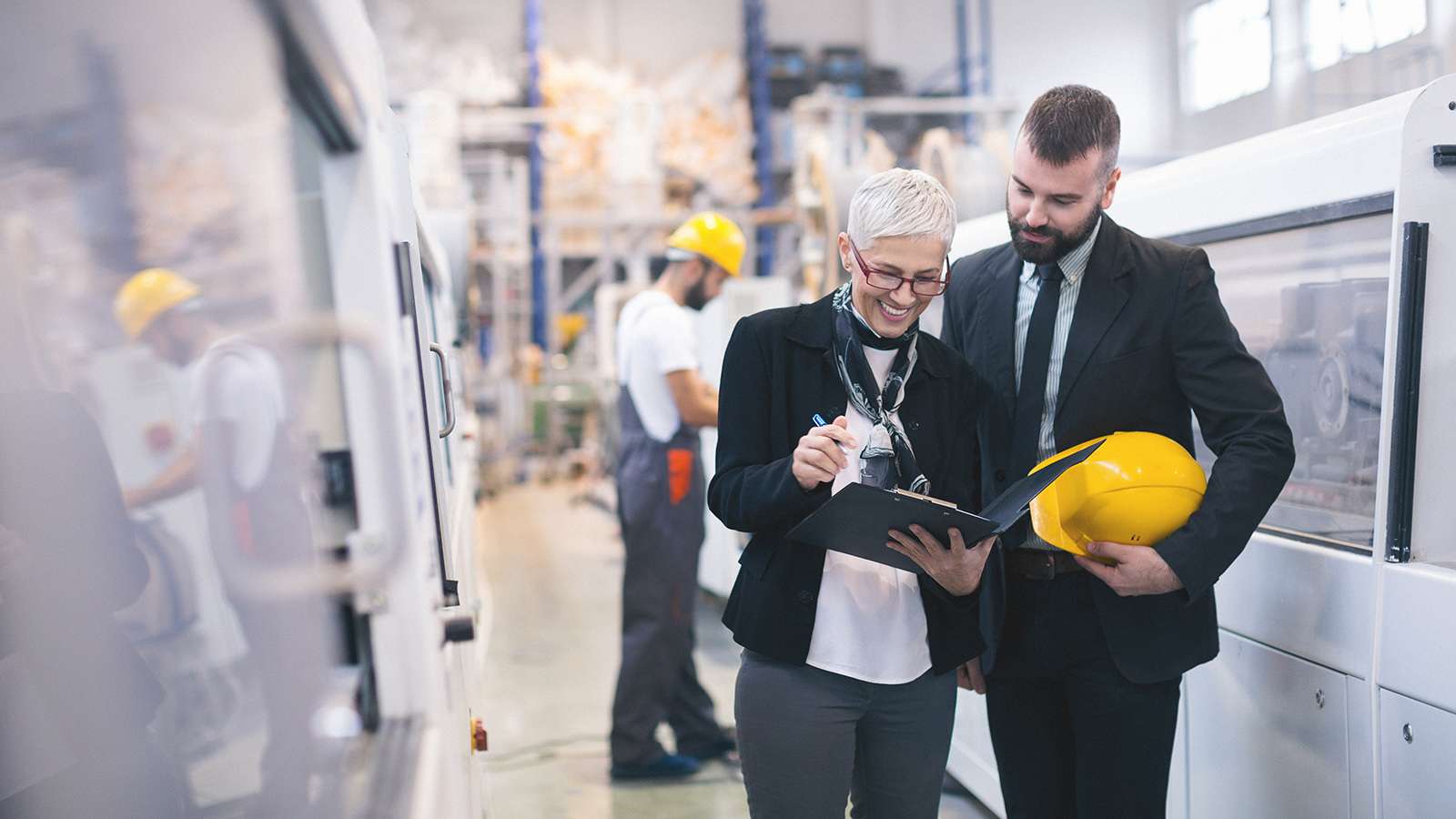 businesspeople in a factory