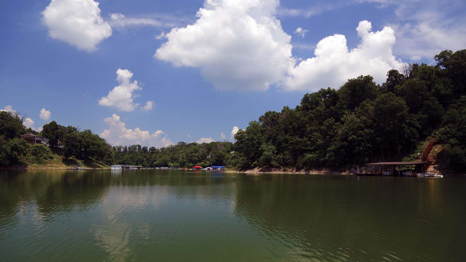 low angle photo of Herrington Lake with boat docks in background