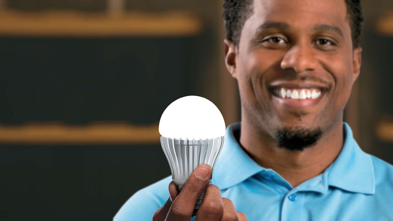 Employee holding LED light bulb
