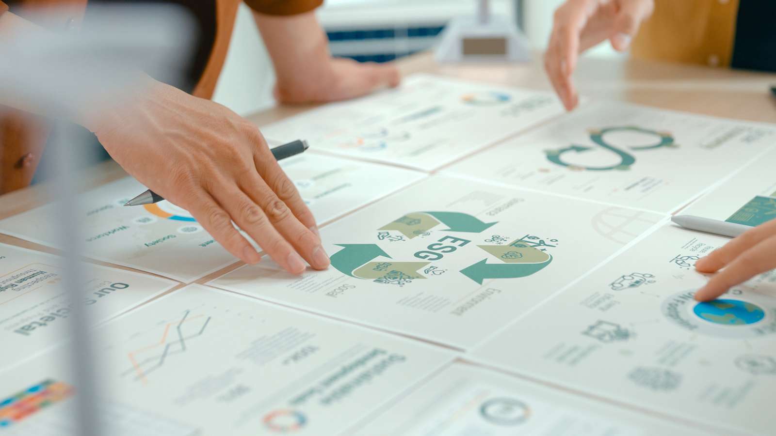 Hands on a table reviewing graphics