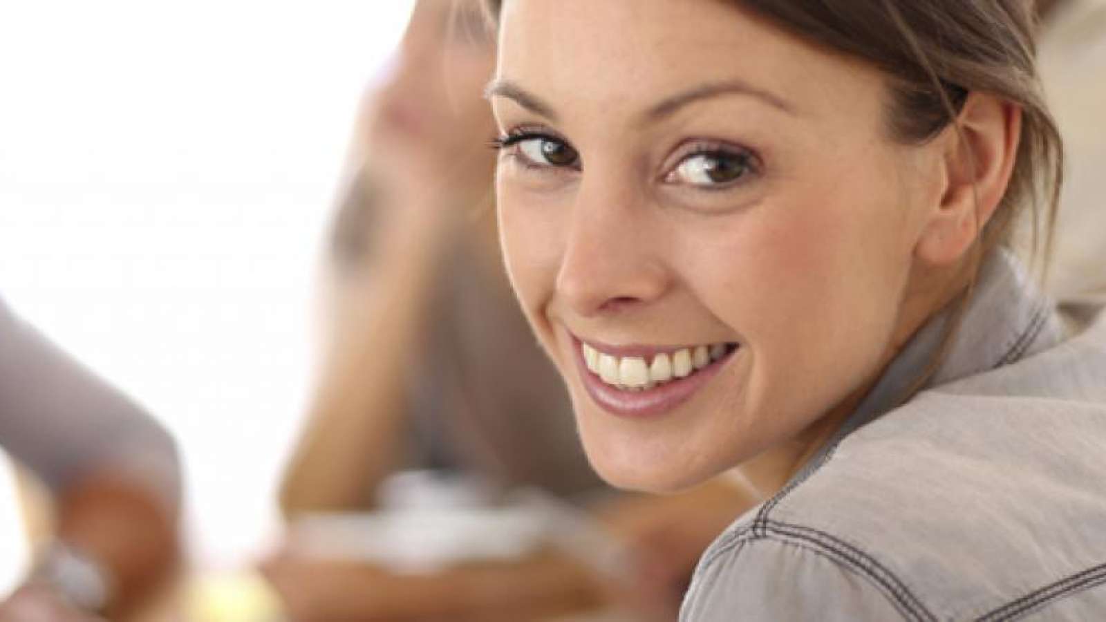 female employee at a meeting looking into the camera