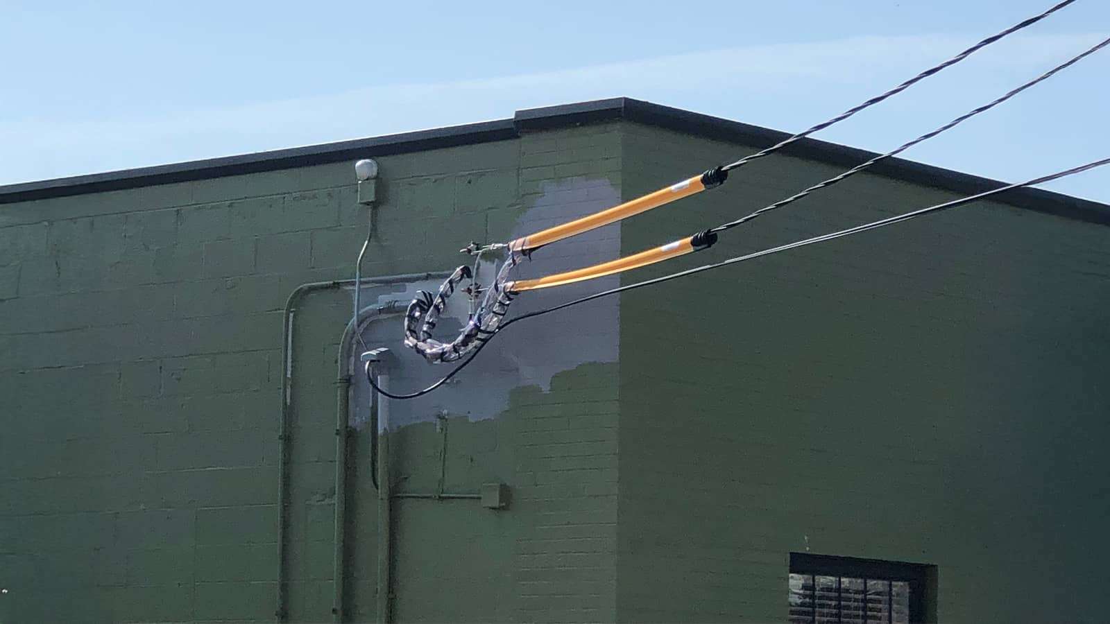 cover drop on a power line outside of a building
