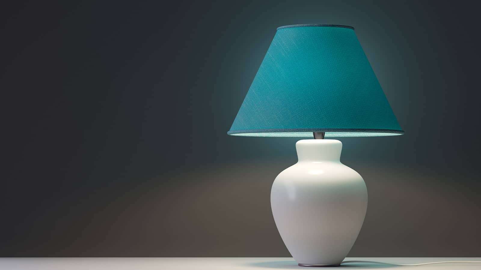 a lighted table lamp on a table