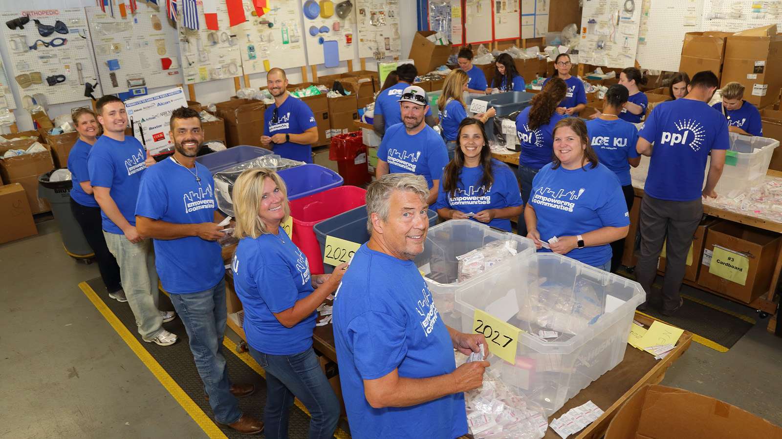 employee volunteers loading care packages