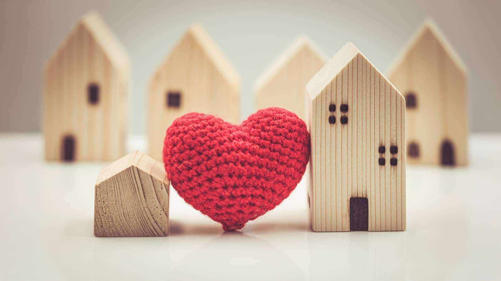 a knit heart among wooden block houses