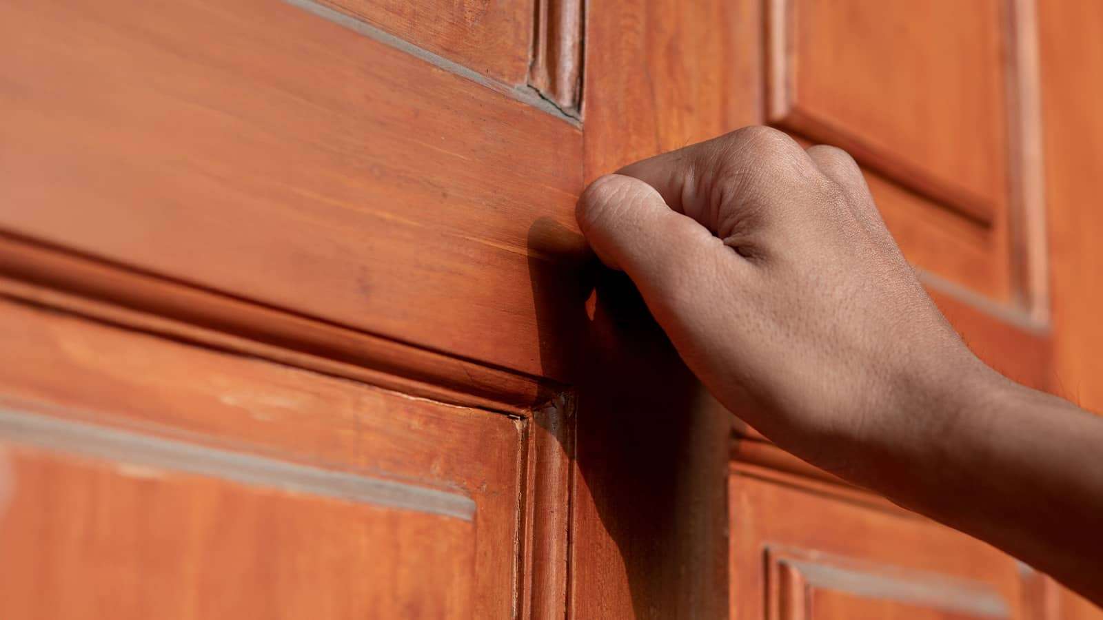 hand knocking on a door