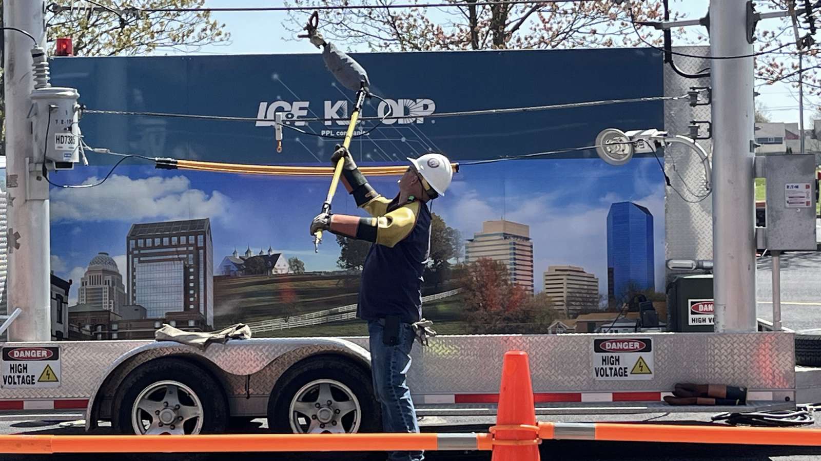 line technician demonstrating live power line safety