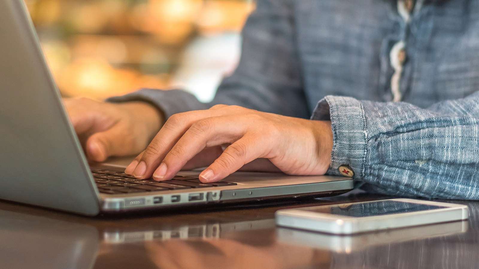 person typing on a laptop