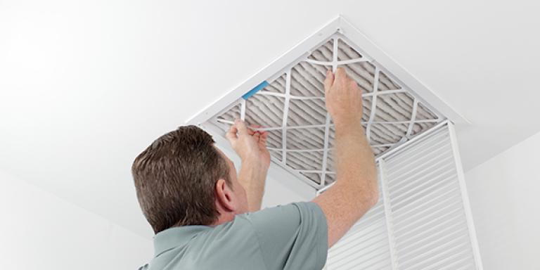 person replacing air filter