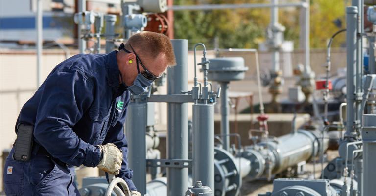 Utility employee working natural gas equipment