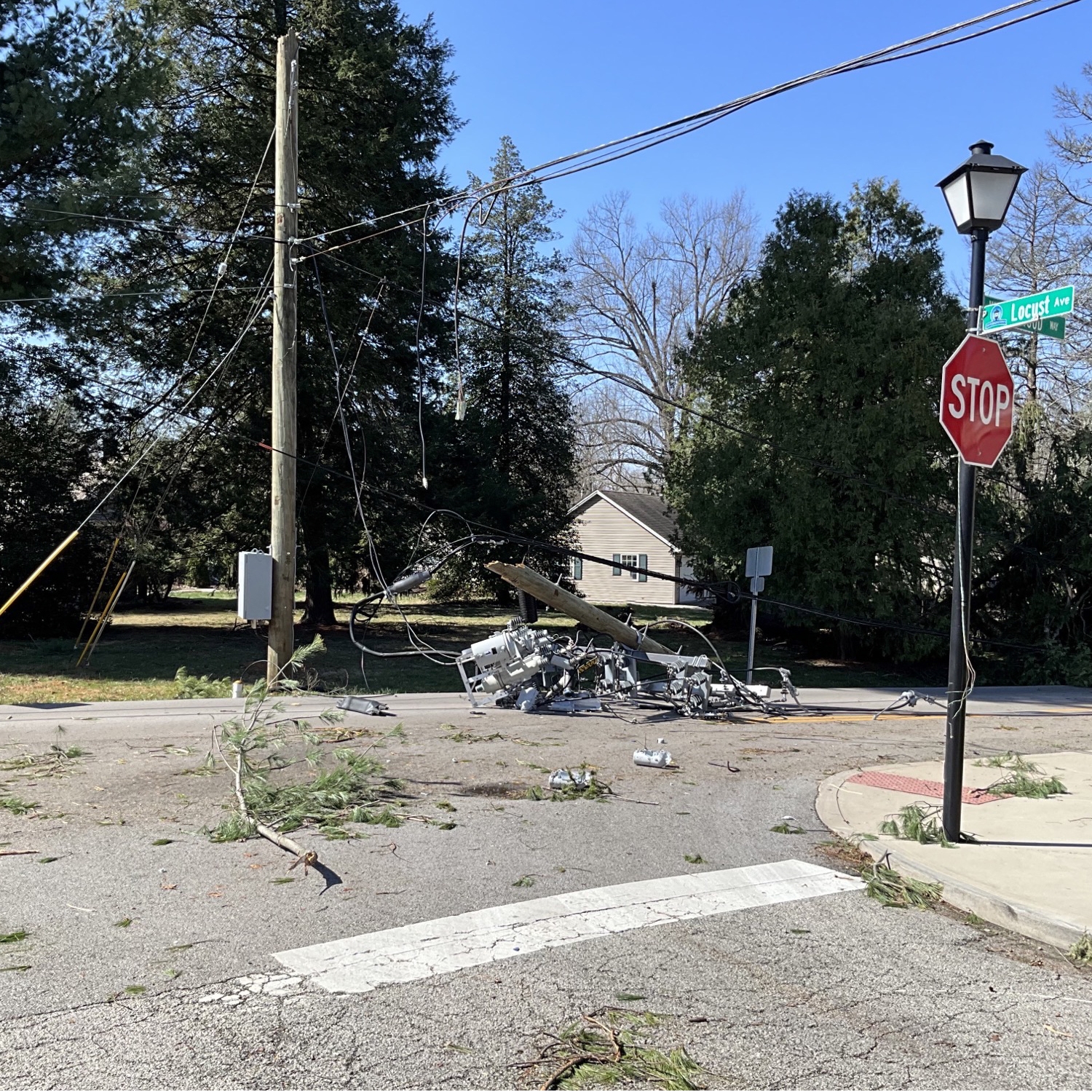 broken pole and downed lines in street