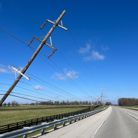 power poles leaning over a road