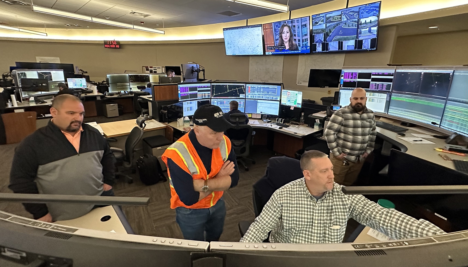 employees looking at monitors in a control center