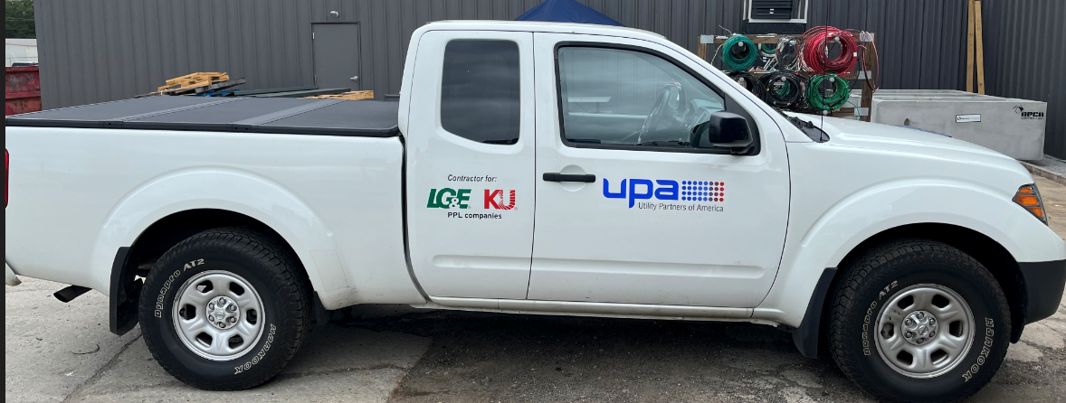 white pickup truck with company and vendor logos