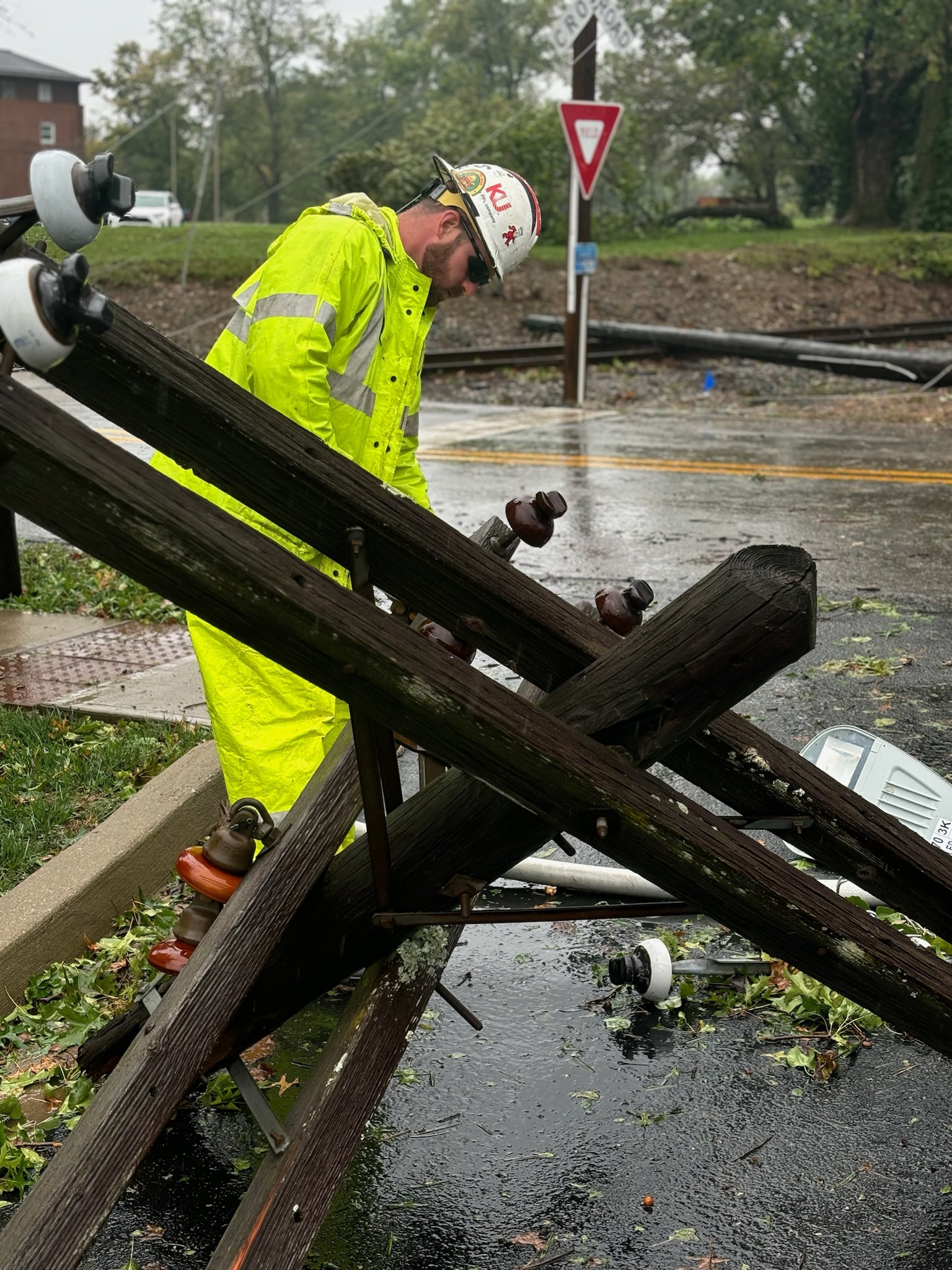 crew inspecting broken power pole