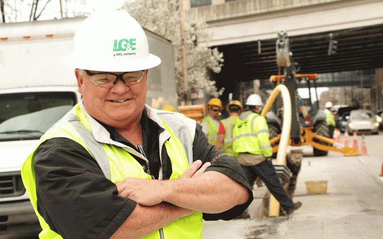 Employee Tom Murphy with hard hat on and arms folded