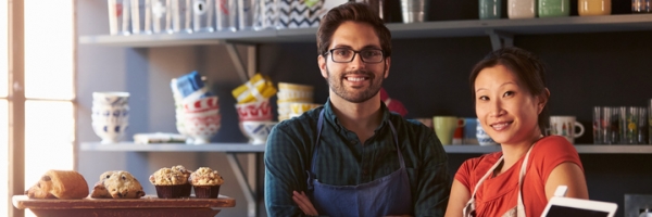 man and woman behind counter at store
