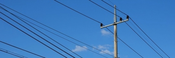 utility pole with power lines against a blue sky