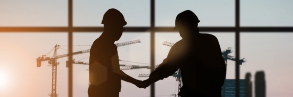 silhouettes of contractors shaking hands
